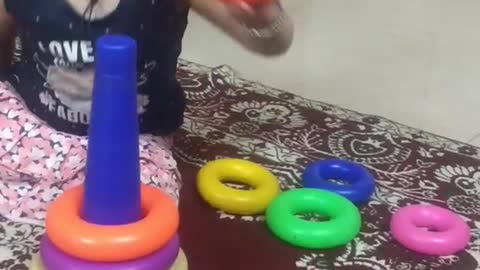 2 year baby playing with Stack Ring and Learning colours