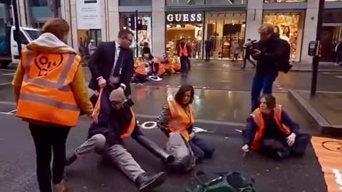 Just Stop Oil protestors try to block traffic in London