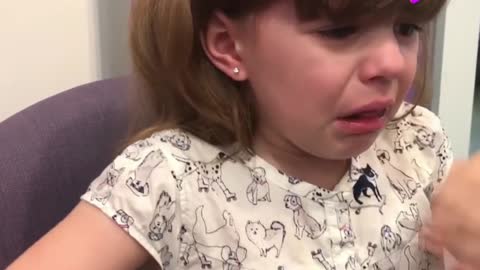 The cute little girl pierced her ears for the first time, crying so distressed!