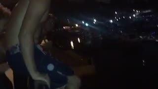 Guy goes night swimming, front flips off bridge and belly flops into water