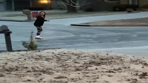 Girl Blissfully Ice Skates around Neighborhood