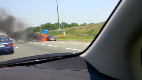 BMW in flames on highway shoulder