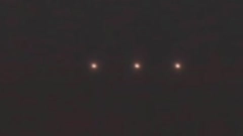 Three Perfectly Aligned Light Orbs Floating Over The Night Skies