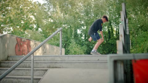 Skater Jumping Up Steps at Skatepark