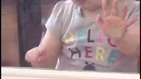 Cute Baby Girl Tries To Lick A Door Open