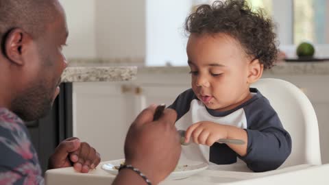 A Father And Child Eating Together