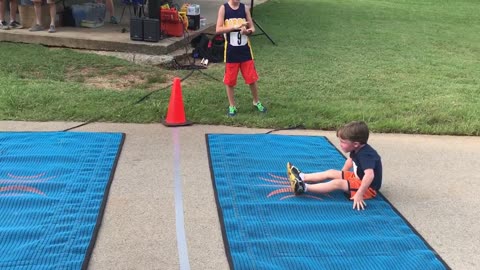 Little Boy Scoots On His Butt To Finish A Race