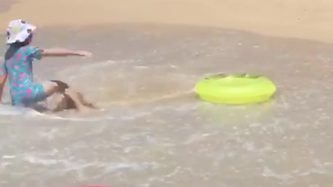 White bucket hat girl tossed around yellow floatie at beach