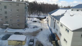 Snow Falling From Roof Pummels Woman