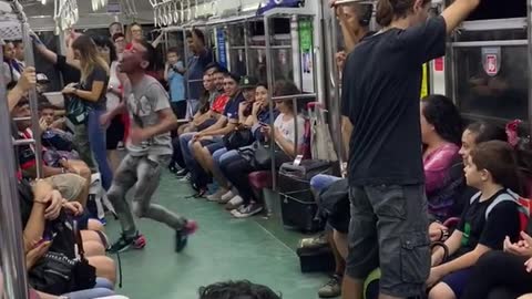 Subway performer dances in subway train with rollerskates to little mermaid song "under the sea"