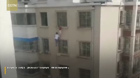 Man rescues a girl dangling from 6th-floor window in superhero-like act