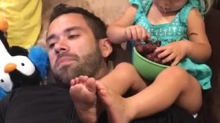 Adorable 2 year old feeds her daddy grapes