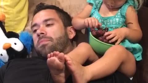 Adorable 2 year old feeds her daddy grapes