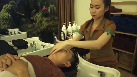 Massage hands, shoulders, neck, head and relaxing shampoo at Vietnamese barbershop