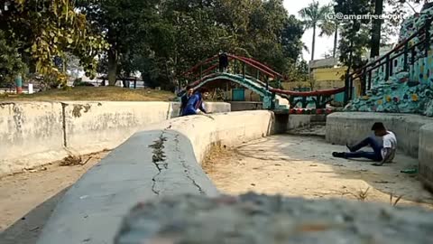 White shirt man attempts flip over drainage ditch hits head concrete