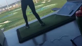 Woman swings club and lets go