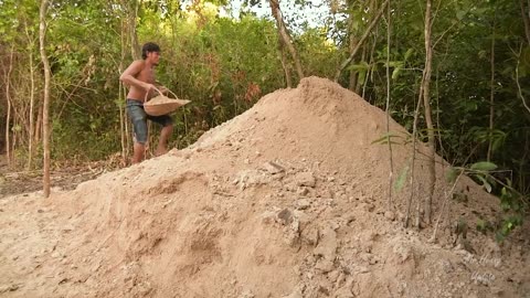 Building underground hut with grass roof & fireplace with clay