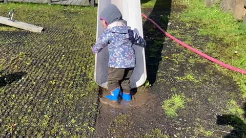 Toodler Enjoying & Jumping on the Mud