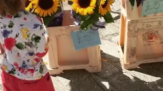 Gorgeous little boy buys flowers for his mum