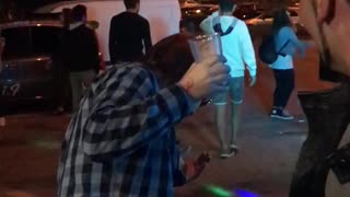 Music guy checkered shirt drinking and dancing