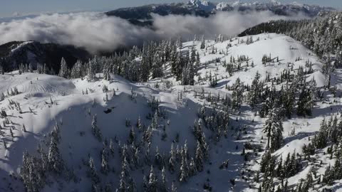 Snowy mountain above the clouds