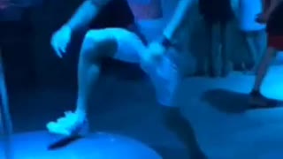 Man in white upside down on pole hits head