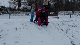 Kids eat snow after crashing on sled