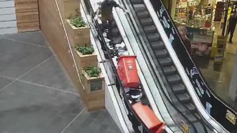 Man Makes a Huge Paper Mess Going Up Escalator
