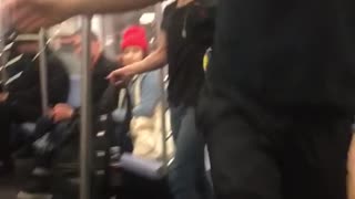 Guy spins upside down on subway train handrail