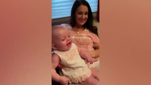 baby laughing with dog barking