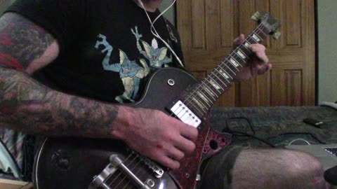 Doing some bluesy fast soloing on the guitar.