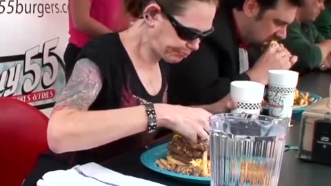 Woman Chowing Down On Huge Burger