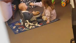 Big Sister Helping Her Little Brother Finish His Dinner