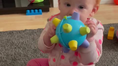 Child loving making silly noises with her toy! Shows Red Head temper when it stops!!