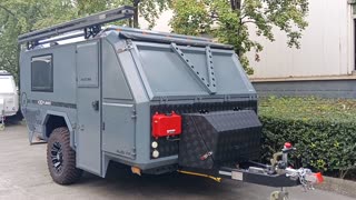 njstar rv domestic customer's grey exterior off road trailer with bike rack a the rear