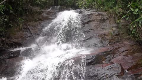 A Man Enjoying The The Scenic Watefalls