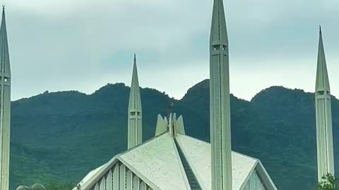 "Harmony in Stone and Nature: Faisal Mosque Framed by Breathtaking Hills"