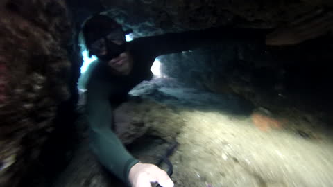 Narrow underwater cave nearly traps risky diver