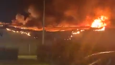 A large shopping center in the suburbs of Paris is completely destroyed by fire.