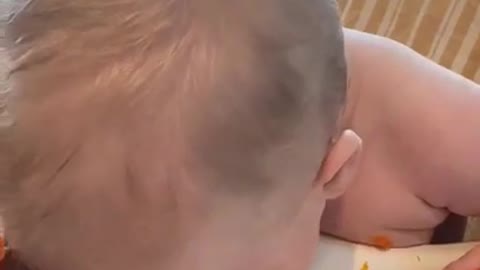 Baby Sitting in High Chair Puts His Head in Bowl of Food While Eating