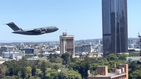Pilot Flies Between Buildings