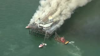 Massive fire is DESTROYING the historic Oceanside Pier in California.