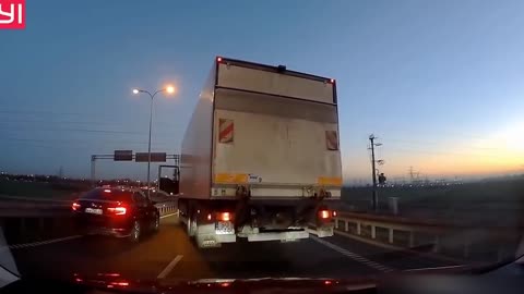 The pissed off truck driver ran to the driver because he dared to overtake him.