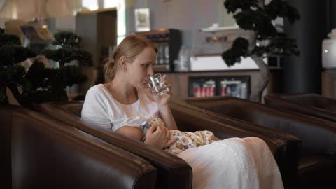 Mother breastfeeding her baby in a hotel