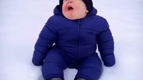 Funny child playing the snow