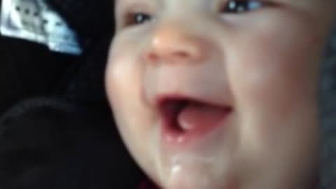 Baby giggles at herself while blowing raspberries