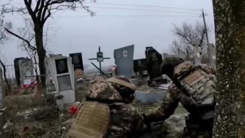 Ukrainian soldier positioned in cemetery