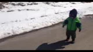 Toddler attempts to catch his own shadow