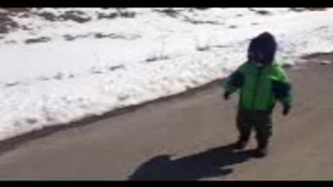 Toddler attempts to catch his own shadow