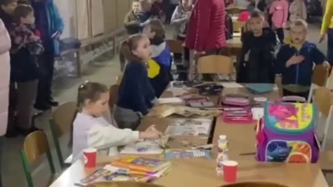 Ukrainian children sing the Ukrainian anthem in a bomb shelter during the Russian attacks on Kyiv